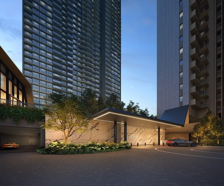 The Orie, artist&rsquo;s impression: the arrival court at dusk, a lit porte-cochere with a stone feature wall at the foot of the towers