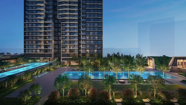 The Orie, artist&rsquo;s impression: the landscaped deck at dusk seen from above, the pools lit between the gardens at the foot of a tower