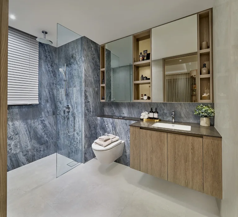 The Orie show-unit interior, for illustration only: a bathroom with a blue-grey stone shower wall, a timber vanity and a mirrored cabinet