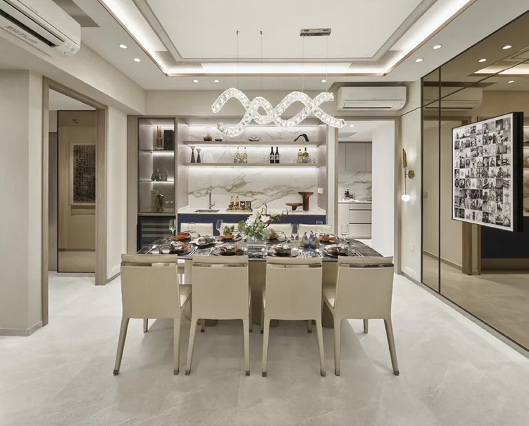 The Orie show-unit interior, for illustration only: a dining room with a marble-topped table for eight, a wine display and a sculptural pendant